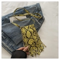 Detailed view of yellow snake print crossbody bag featuring long stylish tassels - Yellow