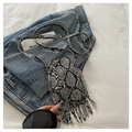 Detail view of snakeskin print leather crossbody bag with long fringe and silver buckle - Gray