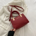 Fashionable burgundy croc-embossed crossbody bag with woven handle and adjustable strap - Burgundy