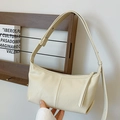 Minimalist cream faux leather baguette bag with vertical stitching and wide strap - Off White