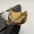 Metallic gold heart-shaped handbag with elegant pearl strap and heart pendant detail - Gold