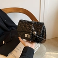 Classic black quilted crossbody bag with silver chain strap and metallic twist lock - Black