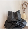 Detail of soft leather texture and metal chain strap on minimalist tote bag - Black