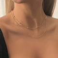 Double-layered 18K gold plated snake chain necklace with beads on a female model - Gold Style (C7377)