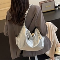Chic silver metallic hobo bag with wrinkled texture and wide strap on model back - Silver