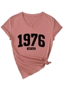 Detail of V-neck dusty rose t-shirt with 1976 vintage print and side knot detail - Dusty Pink (Black Print)