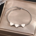 Close-up of stainless steel bracelet featuring three polished heart-shaped pendants on a box chain - Silver Triple Heart Style (C9386)