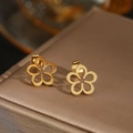 Elegant gold hollow flower stud earrings displayed on a luxury silk jewelry box - Gold (F57)