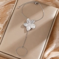 Silver sunflower finger bracelet in stainless steel displayed on gold velvet jewelry box - Silver Flower Style (F862)