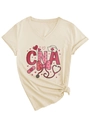 Detail of V-neck CNA scrub shirt with heart nursing print and stylish side knot design - Sand (CNA Print)