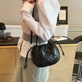 Elegant black quilted crossbody bucket bag with drawstring closure and ribbon detail - Black