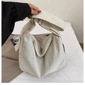 Detail of adjustable wide shoulder strap on beige high-capacity nylon tote crossbody bag - White