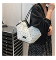 Detail of white tote bag with black bow prints and pearl lace charm on mannequin - With Pearl Lace Charm / White & Black