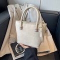 Chic beige textured crossbody bag with cylindrical handles and adjustable strap - White