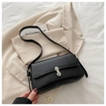 Minimalist black leather underarm bag featuring a metallic silver rectangular buckle - Black