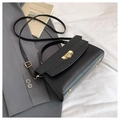 Classic black leather crossbody bag with gold hardware and textured chevron flap cover - Black