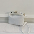 Elegant white crossbody handbag with textured dot pattern and golden metal hardware - White