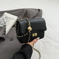 Black pleated shoulder bag with gold chain strap and spherical charm detail - Black