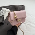 Pink pleated crossbody bag with a golden sphere charm and elegant chain strap detail - Pink