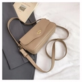 Detail of khaki faux leather crossbody bag with golden oval twist lock on a grey suit - Dark Khaki