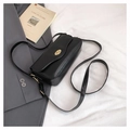 Close-up of black matte leather crossbody bag featuring a golden oval twist lock - Black