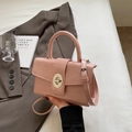 Pink crocodile embossed leather handbag with silver lock and adjustable crossbody strap - Pink