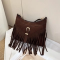 Close-up of dark coffee suede tote bag with fringe tassel and metallic buckle detail - Brown