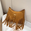 Close-up of bohemian brown suede tote bag featuring long fringes and gold buckle detail - Brown