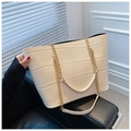 Detail of off-white tote bag featuring crocodile embossed texture and golden chain strap - White