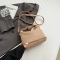Beige pleated crossbody bag with pebble grain leather texture and gold buckle detail - Khaki