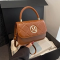 Quilted caramel brown crossbody bag with gold M logo in a premium gift box setup - Brown