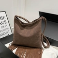 Retro dark brown faux suede shoulder bag featuring long tassels in a minimalist boho style - Brown