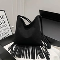 Minimalist black suede tote bag featuring long tassels and cylindrical shoulder straps - Black