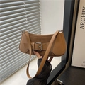 Close-up of brown baguette bag with vintage buckle and mixed leather texture detail - Khaki
