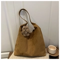 Detailed texture of brown suede tote bag featuring a cute plush puppy charm on a strap - With Pendant / Brown