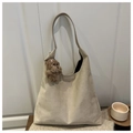 Detail view of beige suede tote bag with a cute plush bear charm in a home setting - With Pendant / Khaki