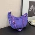 Detail of purple nylon crescent bag featuring wide adjustable strap and side pocket - Purple