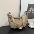 Detail of khaki nylon crescent bag with adjustable wide strap and knotted zipper pulls - Khaki