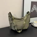 Olive green nylon crescent bag detail featuring woven strap and rope zipper pull - Green