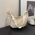 Detail of minimalist beige nylon crescent bag with wide strap and side knot accents - White