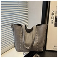 Detail of grey suede tote bag with silver studs and premium texture on shoulder straps - Gray