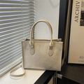 Beige tote bag with clover embossing, featuring top handles and a long shoulder strap - White
