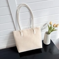 Close-up of beige minimalist tote bag on a desk with tulips in a home studio setting - Off White