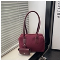 Detail of burgundy suede pillow bag with matching mini coin purse and slender handles - Red