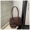 Detail of dark brown suede bowling bag with mini pouch and smooth leather handles - Brown