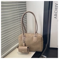 Detail of tan suede tote bag with matching mini pouch accessory on a windowsill - Khaki