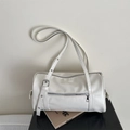 Detail of white barrel bag with silver zippers, adjustable strap and faux leather texture - White