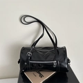 Detail of glossy black patent leather Boston bag with silver zippers and buckles - Black