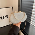 Macro shot of silver sequin evening clutch featuring a metallic gold bow clasp - Silver