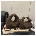 Detail view of brown teddy fur handbags in two sizes with leather straps and silver hardware - Large / Brown